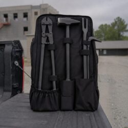 The 911 Backpack Entry Kit open on a tailgate: BoltMaster, ThunderMaul, and Halligan staged in the L.A. Rescue pack