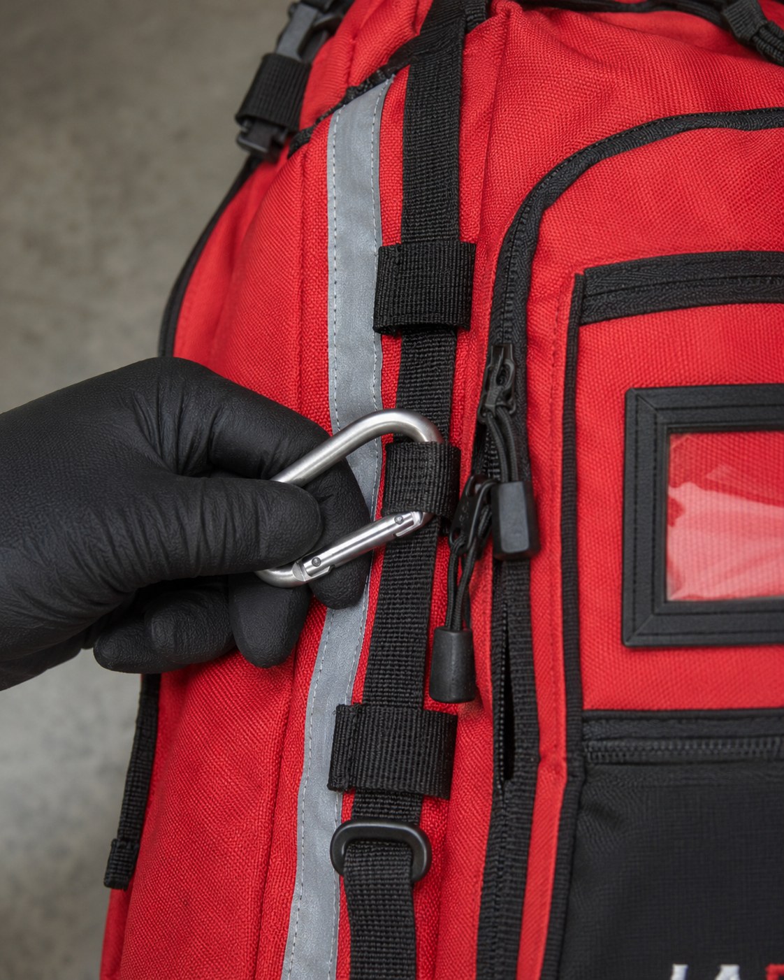 Clipping a carabiner to the deployment pack’s daisy-chain equipment line