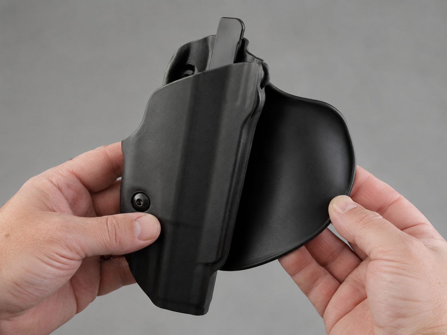 The curved paddle back of the Safariland 6378 concealment holster shown in hand
