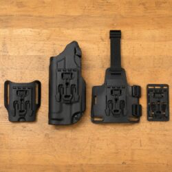 One Safariland holster with a QLS 19 fork beside belt, leg shroud, and MOLLE platforms fitted with QLS 22 receivers