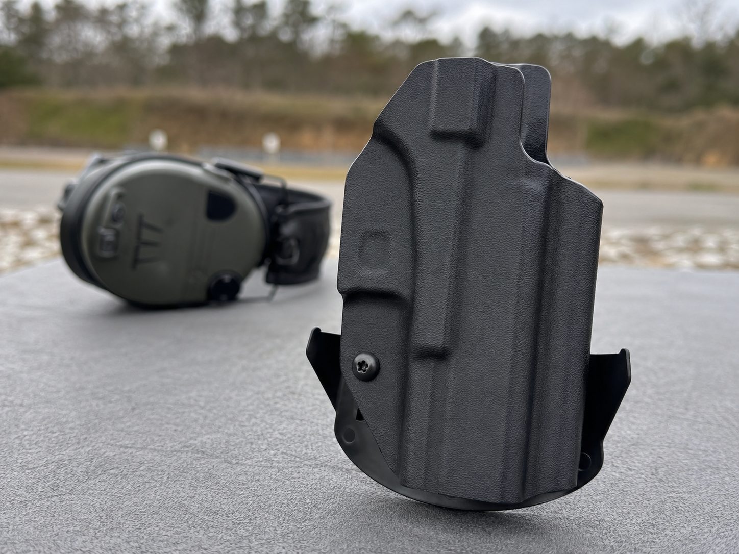 Empty We The People OWB shell showing the red-dot clearance cut and weapon-light channel