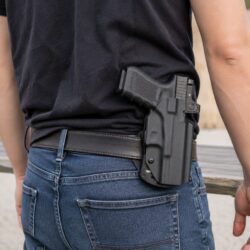 We The People OWB holster carrying a red-dot-equipped Glock 19 MOS with weapon light at the range
